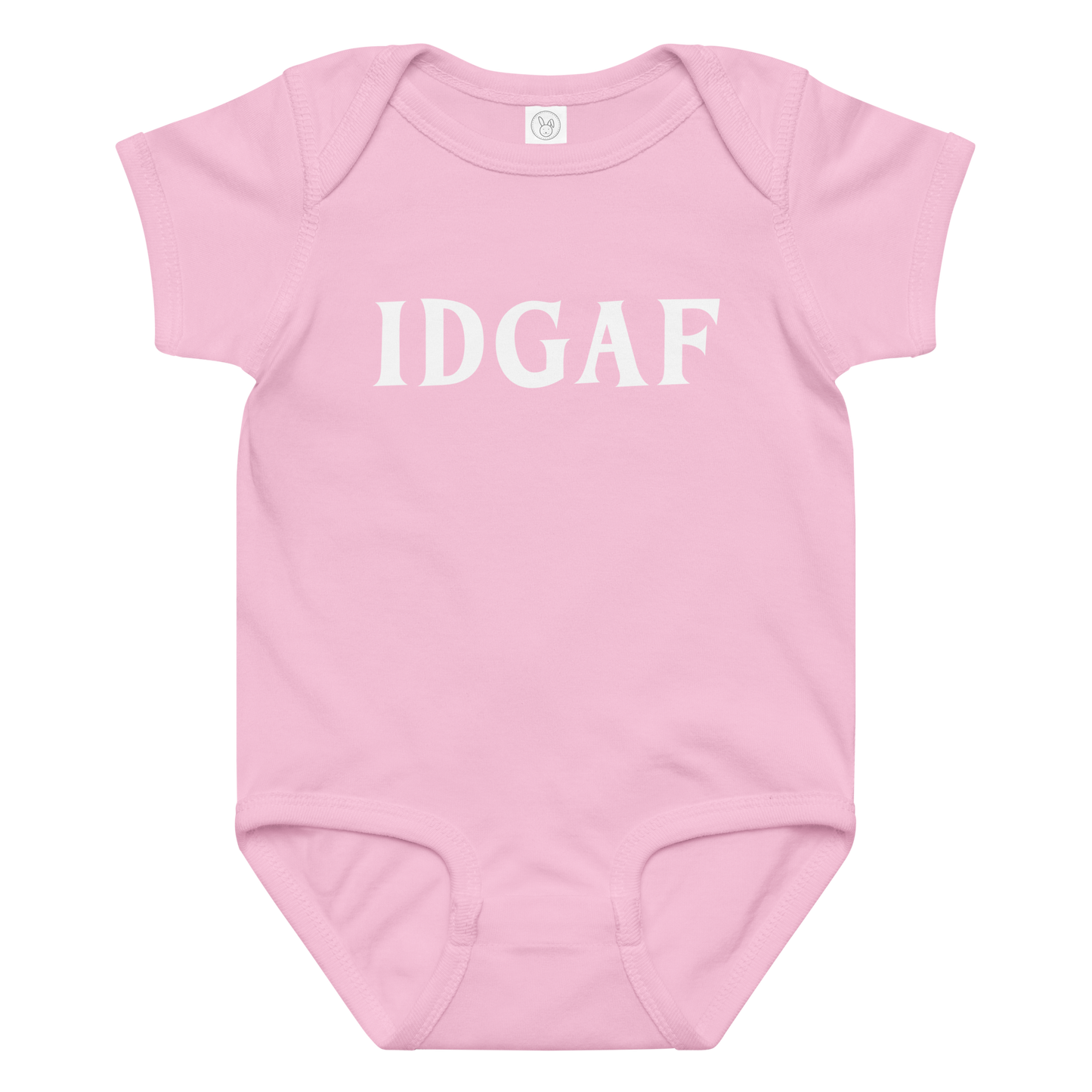 "IDGAF" printed on a pink baby jersey bodysuit laying on a flat surface amongst other clothes