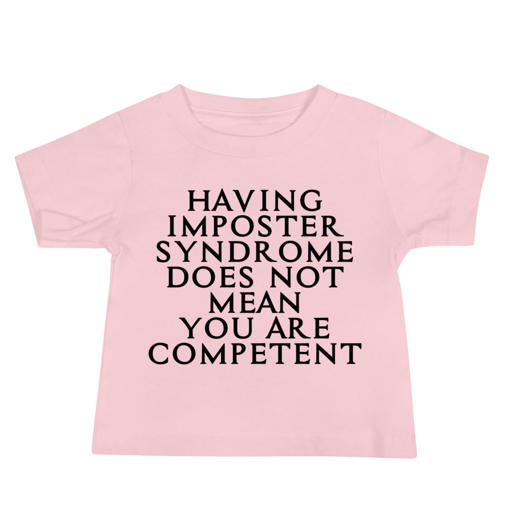 "Having Imposter Syndrome does not mean you are competent" printed on a pink baby jersey short sleeve tee laying on a flat surface