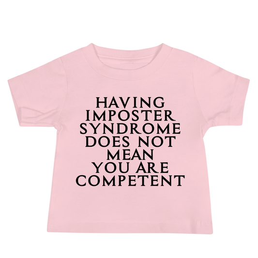 "Having Imposter Syndrome does not mean you are competent" printed on a pink baby jersey short sleeve tee laying on a flat surface