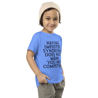 "Having Imposter Syndrome does not mean you are competent" printed on a heather columbia blue toddler short sleeve tee worn by a male who is also wearing a knit cap