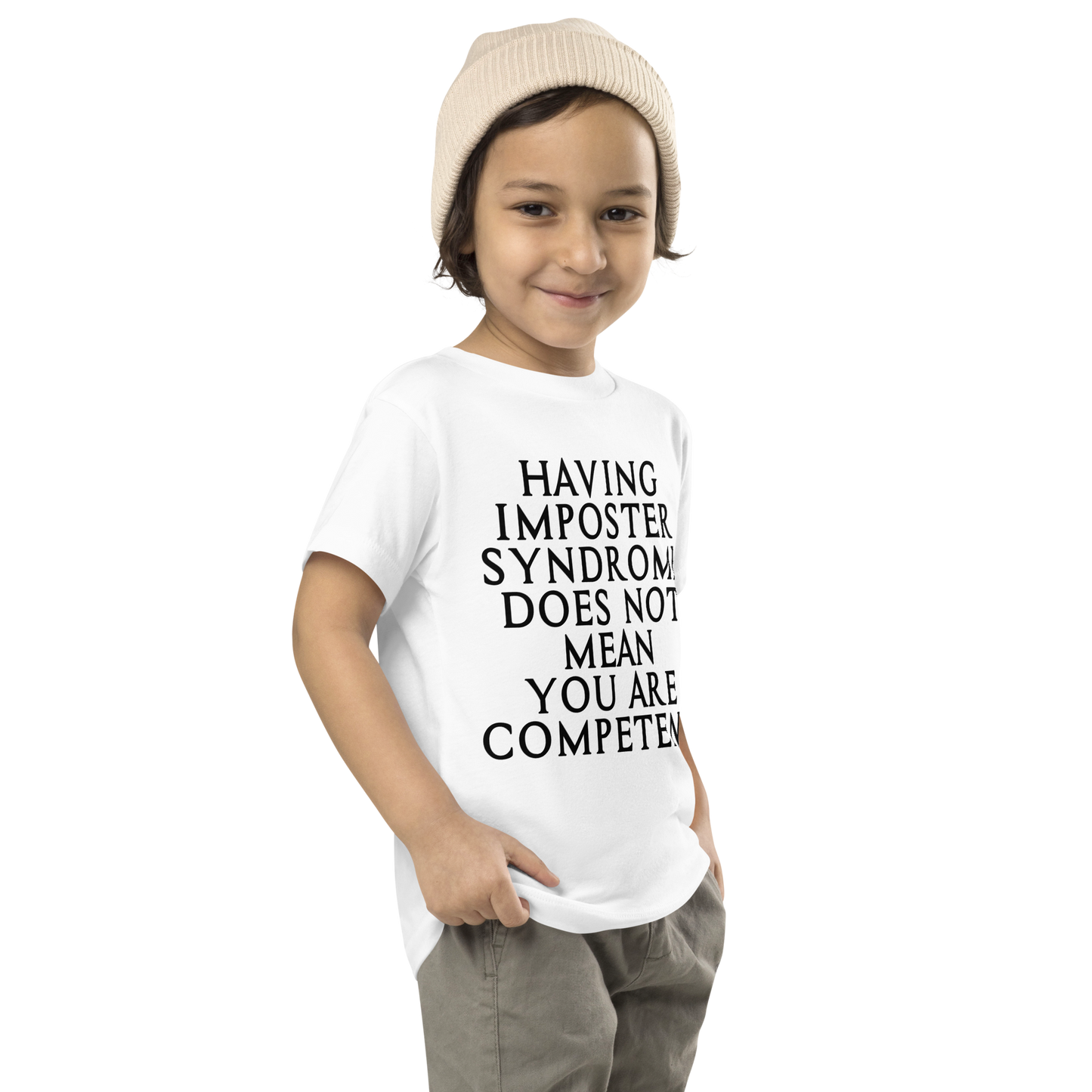 "Having Imposter Syndrome does not mean you are competent" printed on a white toddler short sleeve tee worn by a male who is also wearing a knit cap