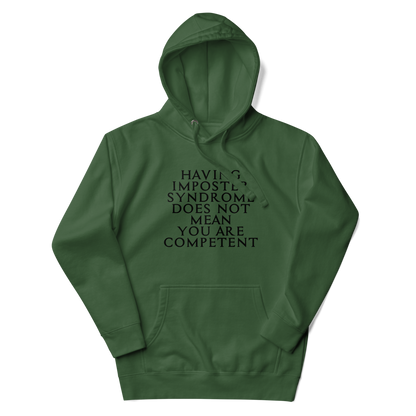 "Having Imposter Syndrome does not mean you are competent" printed on a forest green unisex hoodie laying on a flat surface with the hood up