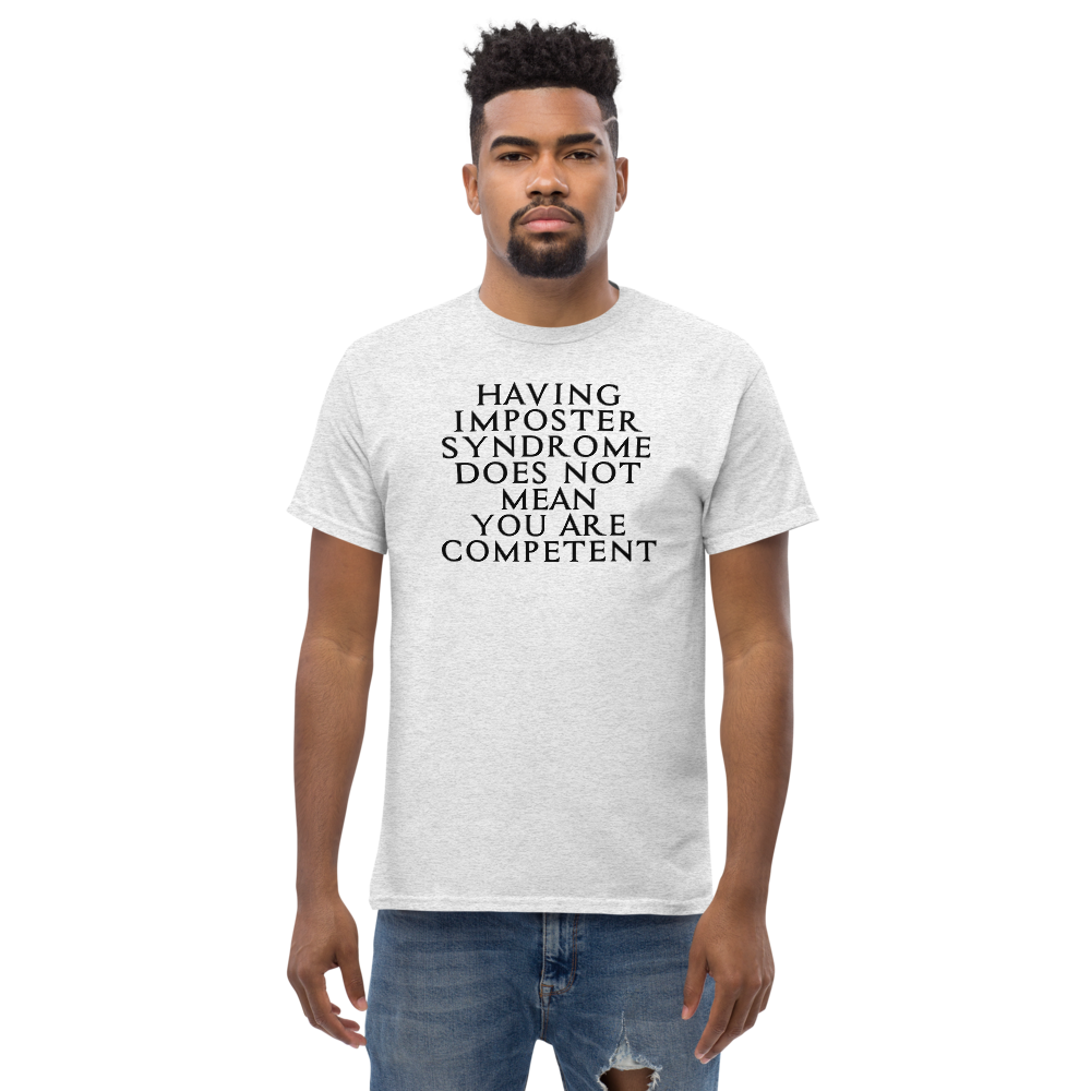 "Having Imposter Syndrome does not mean you are competent" printed on a ash unisex classic tee worn by a male