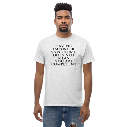 "Having Imposter Syndrome does not mean you are competent" printed on a ash unisex classic tee worn by a male