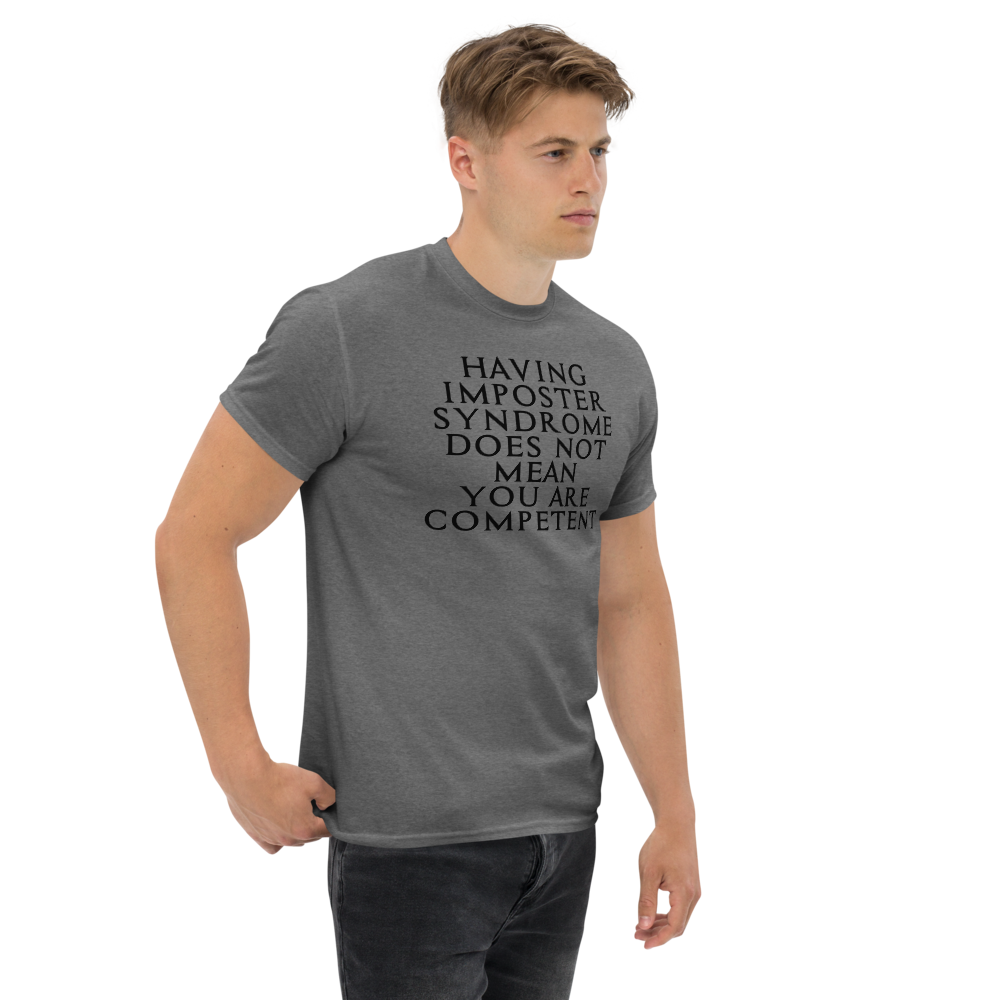 "Having Imposter Syndrome does not mean you are competent" printed on a graphite heather unisex classic tee worn by a male