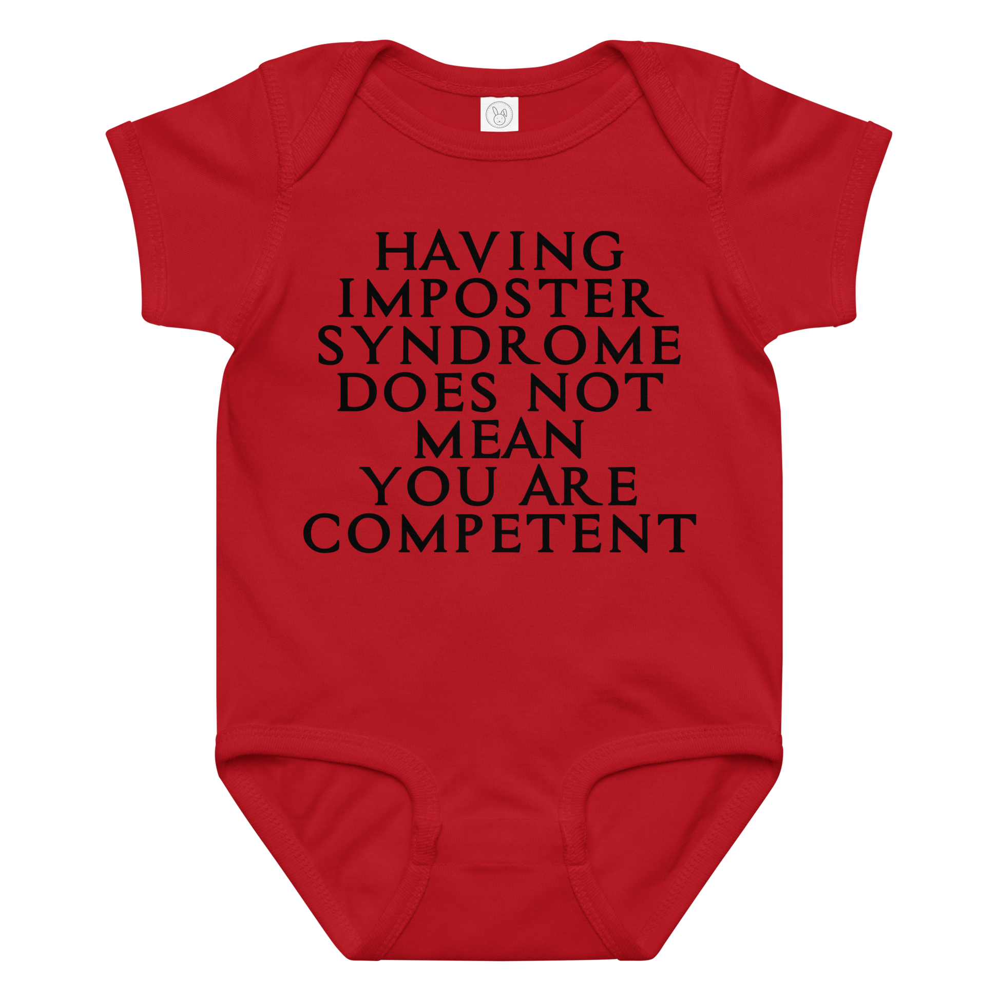 "Having Imposter Syndrome does not mean you are competent" printed on a red baby jersey bodysuit laying on a flat surface amongst other clothes