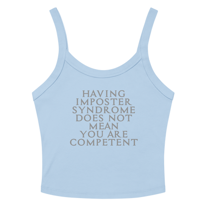 "Having Imposter Syndrome does not mean you are competent" printed on a solid baby blue blend women's micro-rib tanktop laying on a flat surface amongst sunglasses and shorts