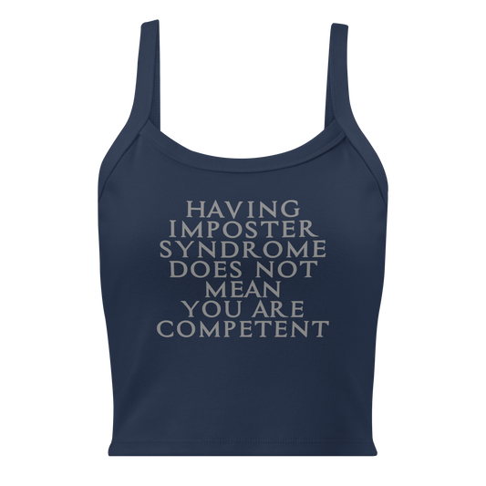 "Having Imposter Syndrome does not mean you are competent" printed on a solid navy blend women's micro-rib tanktop laying on a flat surface