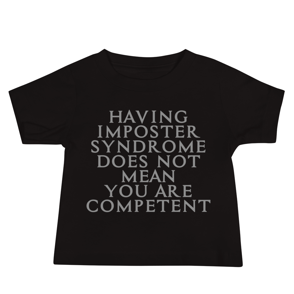 "Having Imposter Syndrome does not mean you are competent" printed on a black baby jersey short sleeve tee laying on a flat surface