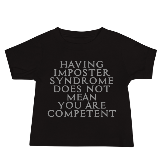 "Having Imposter Syndrome does not mean you are competent" printed on a black baby jersey short sleeve tee laying on a flat surface