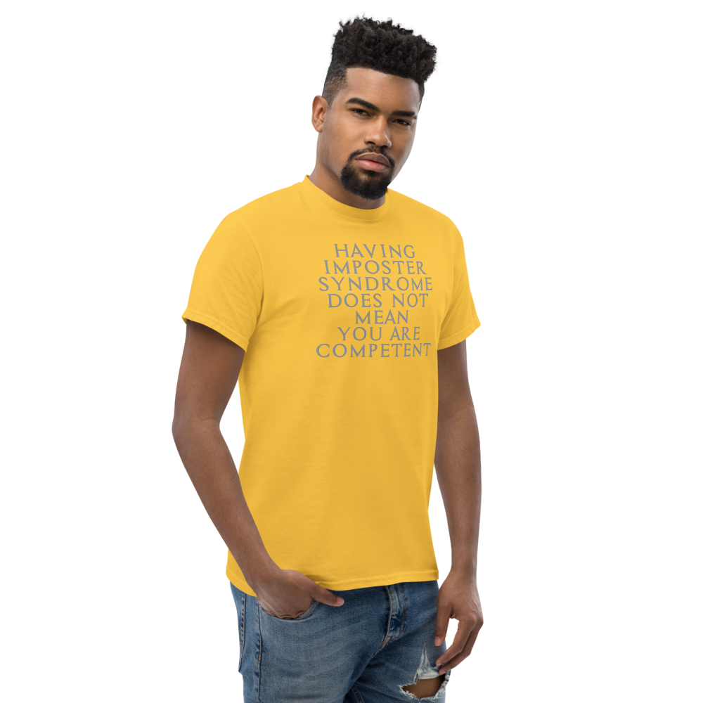 "Having Imposter Syndrome does not mean you are competent" printed on a daisy unisex classic tee worn by a male