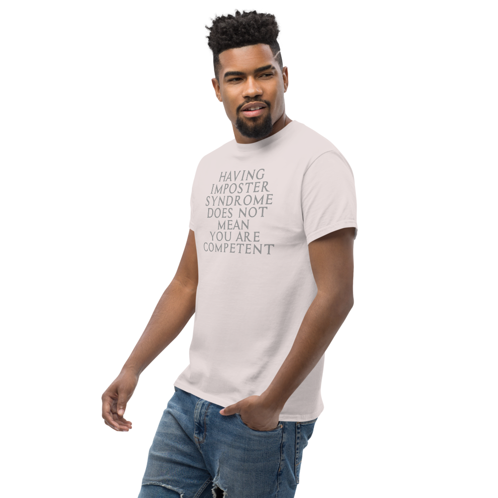 "Having Imposter Syndrome does not mean you are competent" printed on a ice grey unisex classic tee worn by a male