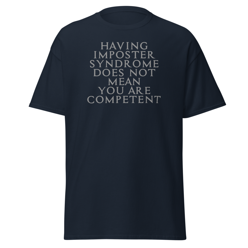 "Having Imposter Syndrome does not mean you are competent" printed on a navy unisex classic tee laying on a flat surface