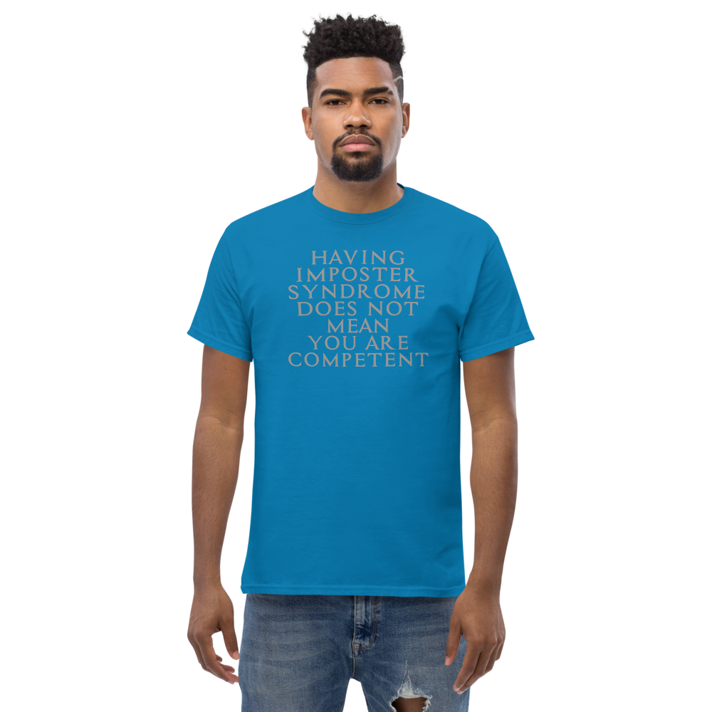 "Having Imposter Syndrome does not mean you are competent" printed on a sapphire unisex classic tee worn by a male