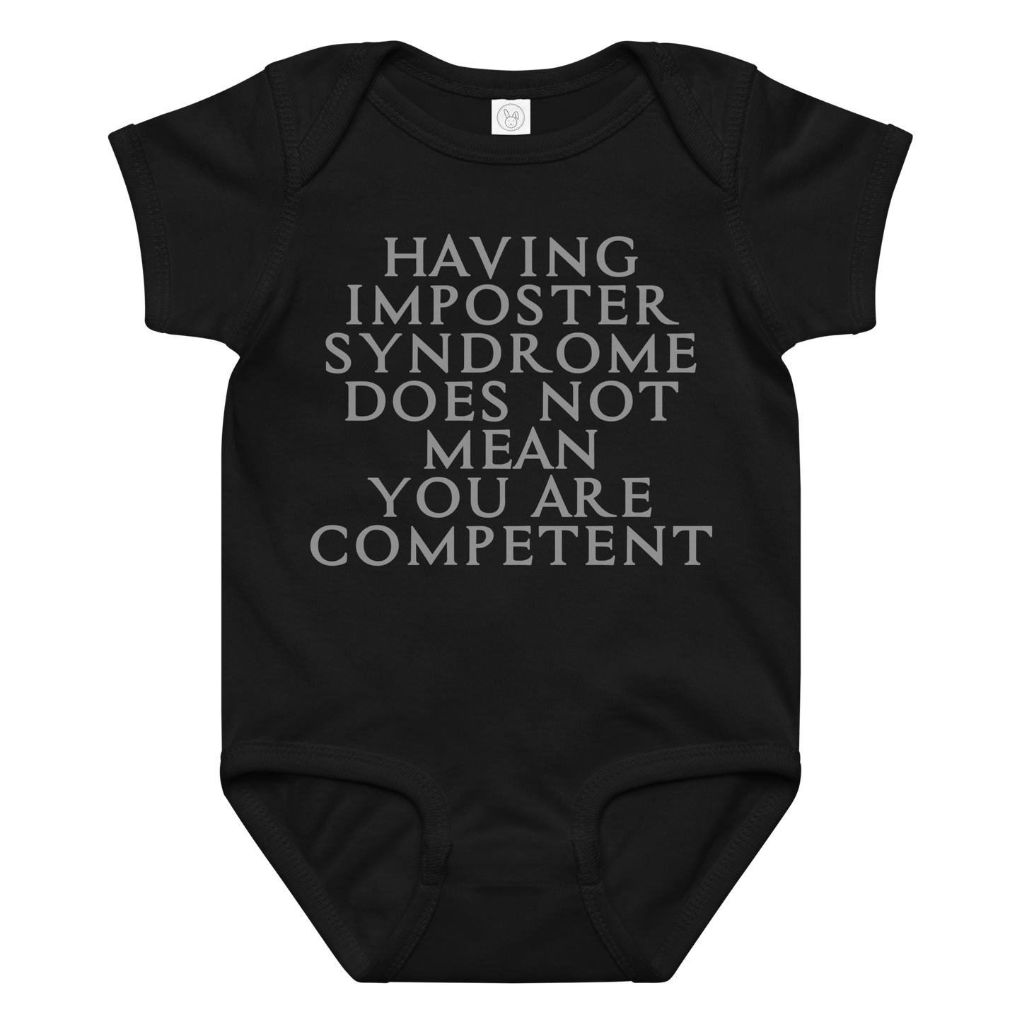 "Having Imposter Syndrome does not mean you are competent" printed on a black baby jersey bodysuit laying on a flat surface amongst other clothes