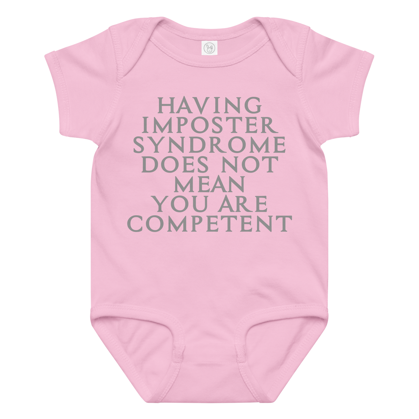 "Having Imposter Syndrome does not mean you are competent" printed on a pink baby jersey bodysuit laying on a flat surface amongst other clothes
