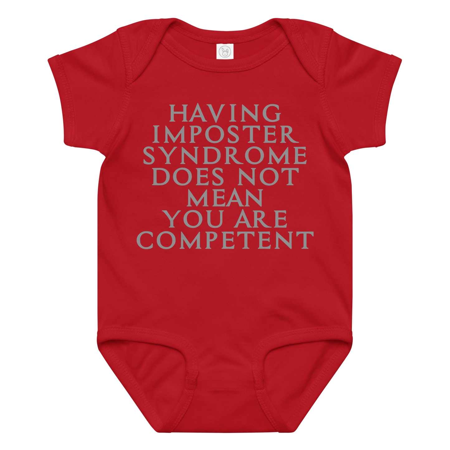"Having Imposter Syndrome does not mean you are competent" printed on a red baby jersey bodysuit laying on a flat surface amongst other clothes