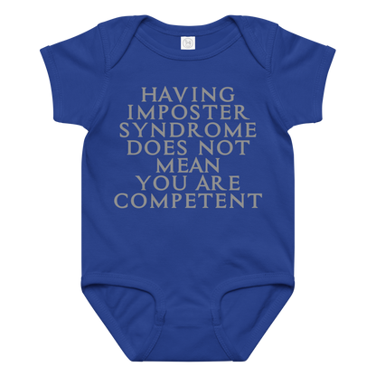 "Having Imposter Syndrome does not mean you are competent" printed on a royal baby jersey bodysuit laying on a flat surface amongst other clothes