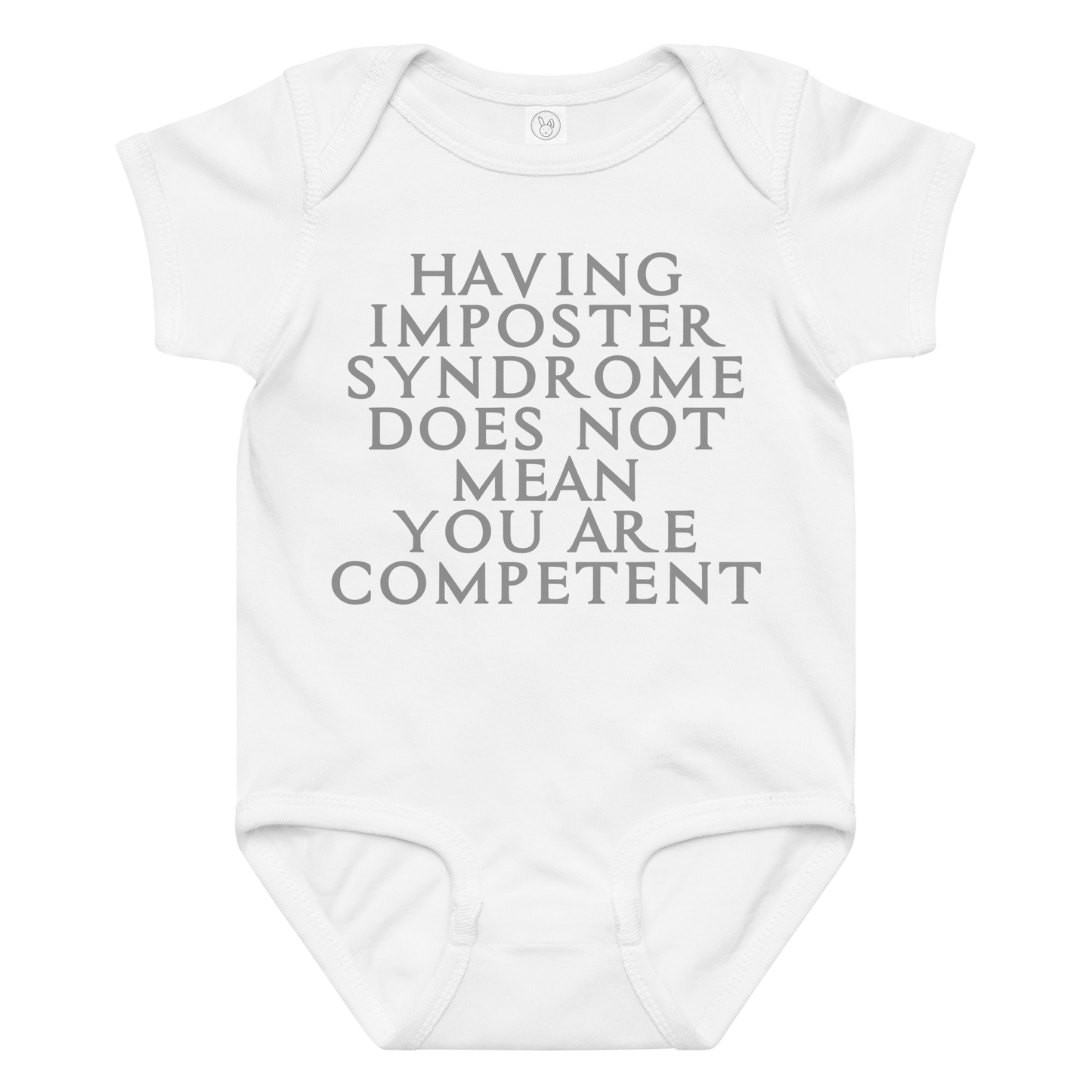 "Having Imposter Syndrome does not mean you are competent" printed on a white baby jersey bodysuit laying on a flat surface amongst other clothes