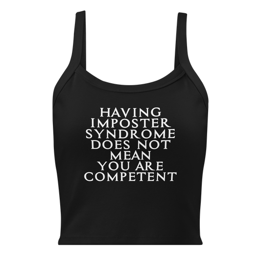 "Having Imposter Syndrome does not mean you are competent" printed on a solid black blend women's micro-rib tanktop laying on a flat surface