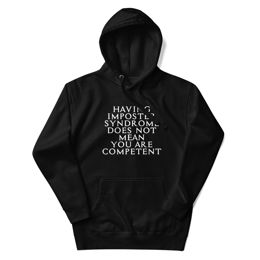 "Having Imposter Syndrome does not mean you are competent" printed on a black unisex hoodie laying on a flat surface with the hood up