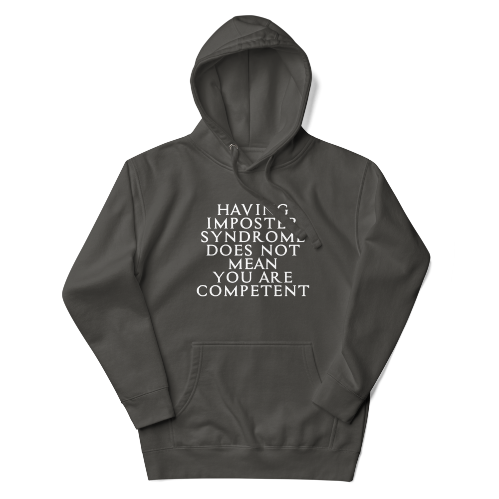 "Having Imposter Syndrome does not mean you are competent" printed on a vintage black unisex hoodie laying on a flat surface with the hood up