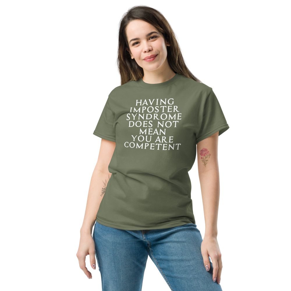 "Having Imposter Syndrome does not mean you are competent" printed on a military green unisex classic tee worn by a female