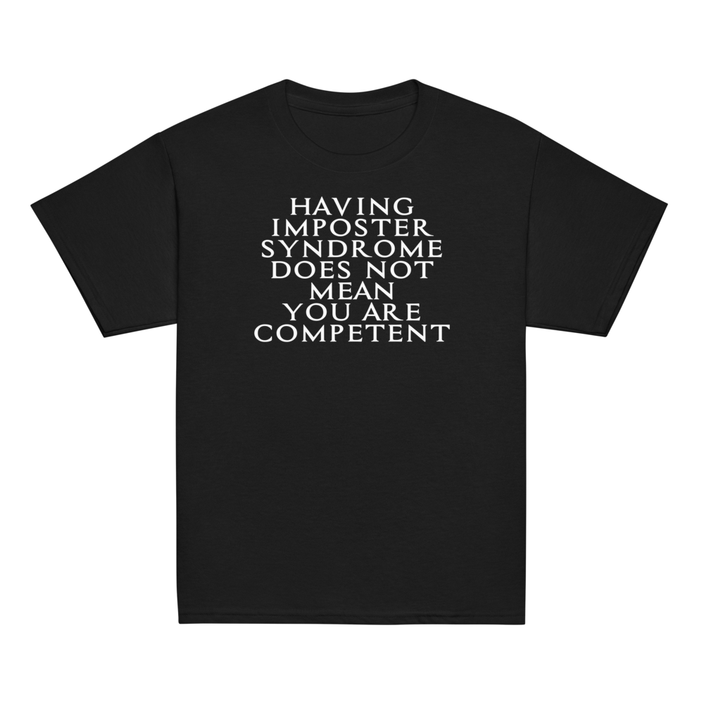 "Having Imposter Syndrome does not mean you are competent" printed on a black youth classic tee laying on a flat surface
