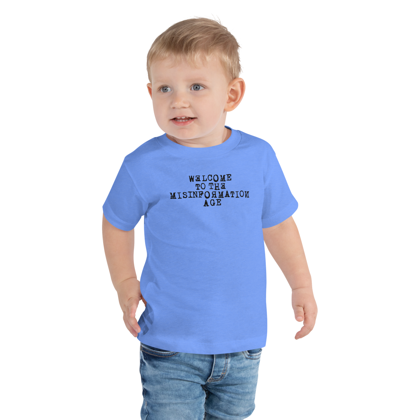 "Welcome to the misinformation age" printed on a heather columbia blue toddler short sleeve tee worn by a male