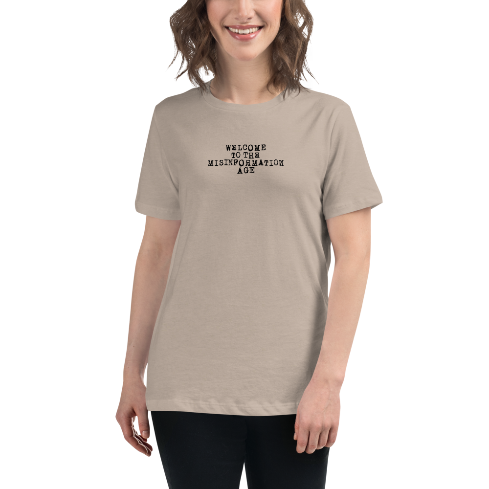 "Welcome to the misinformation age" printed on a heather stone women's relaxed t-shirt worn by a female