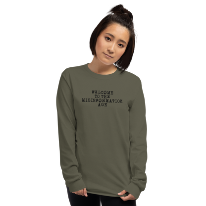 "Welcome to the misinformation age" printed on a military green men's long sleeve shirt worn by a female