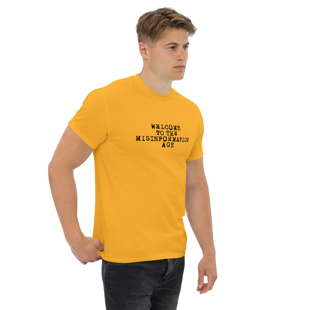 "Welcome to the misinformation age" printed on a gold unisex classic tee worn by a male