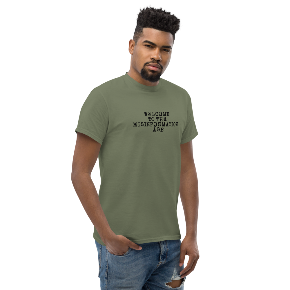 "Welcome to the misinformation age" printed on a military green unisex classic tee worn by a male