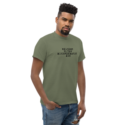 "Welcome to the misinformation age" printed on a military green unisex classic tee worn by a male