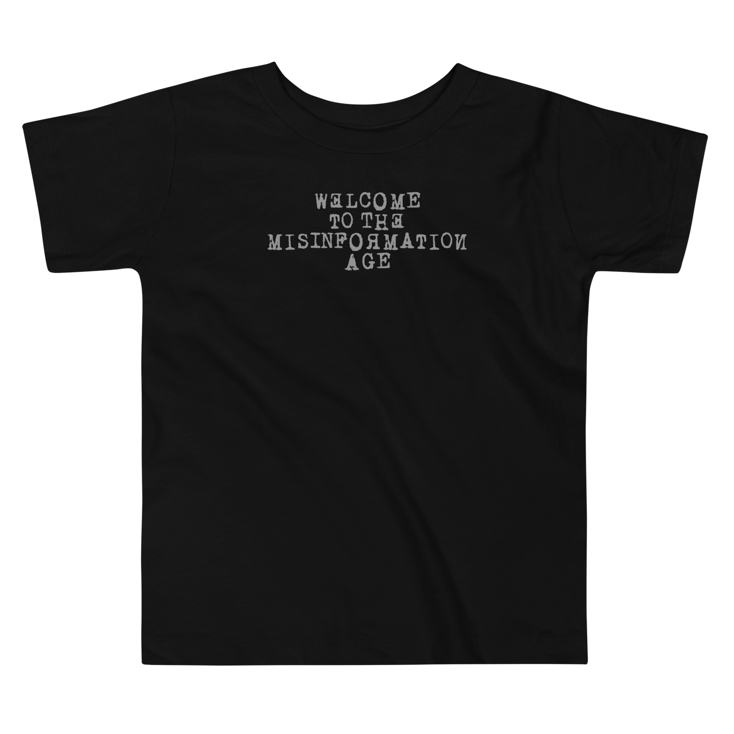 "Welcome to the misinformation age" printed on a black toddler short sleeve tee laying on a flat surface