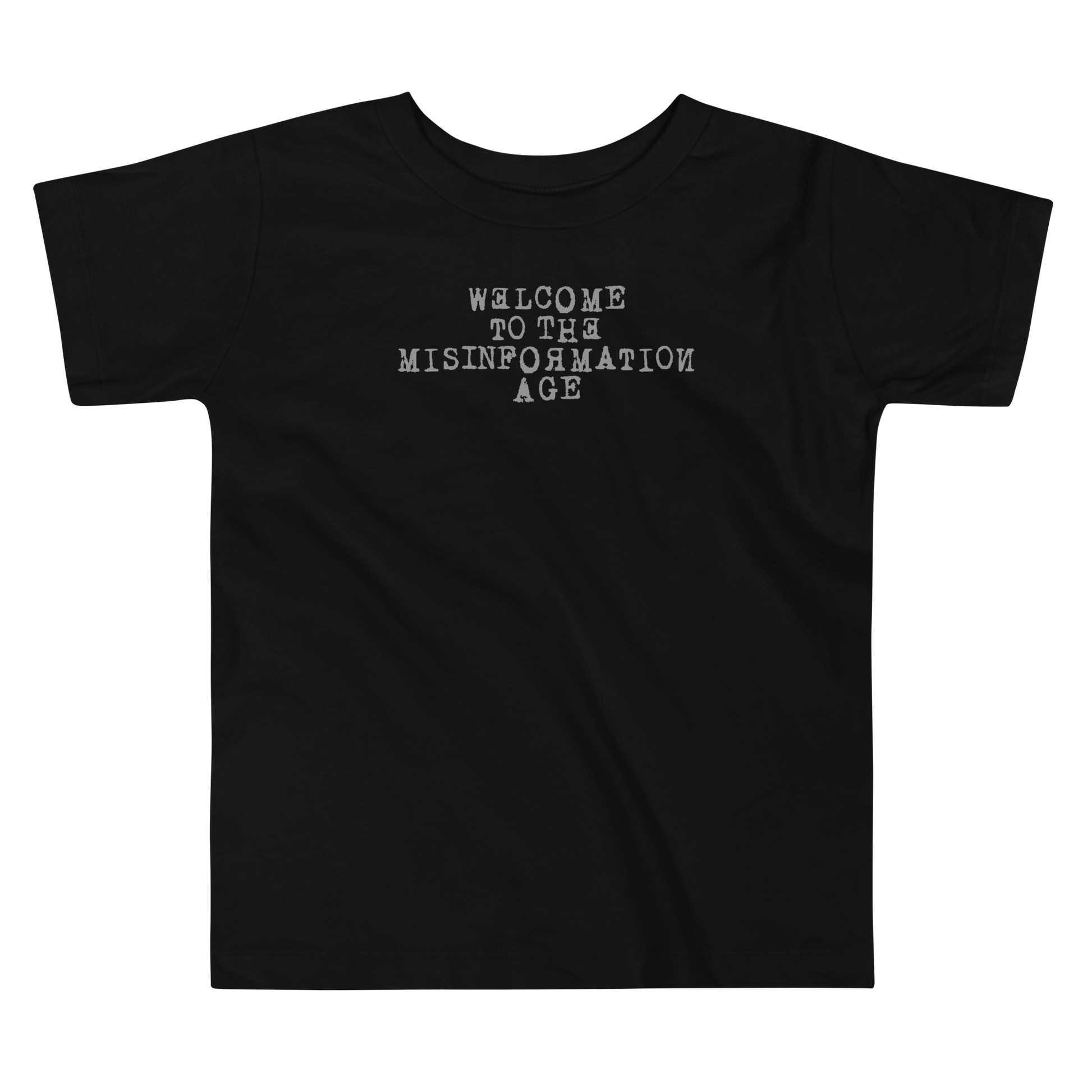 "Welcome to the misinformation age" printed on a black toddler short sleeve tee laying on a flat surface