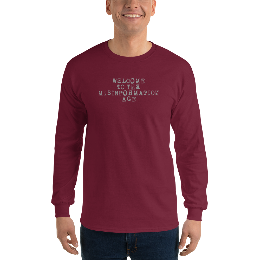 "Welcome to the misinformation age" printed on a maroon men's long sleeve shirt worn by a male