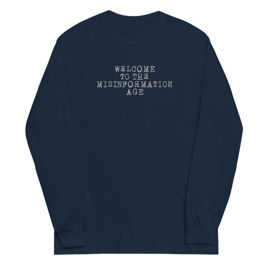 "Welcome to the misinformation age" printed on a navy men's long sleeve shirt laying on a flat surface
