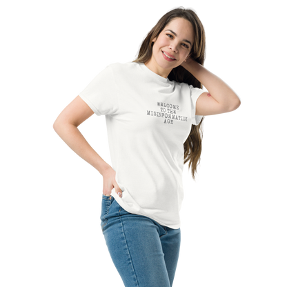 "Welcome to the misinformation age" printed on a white unisex classic tee worn by a female