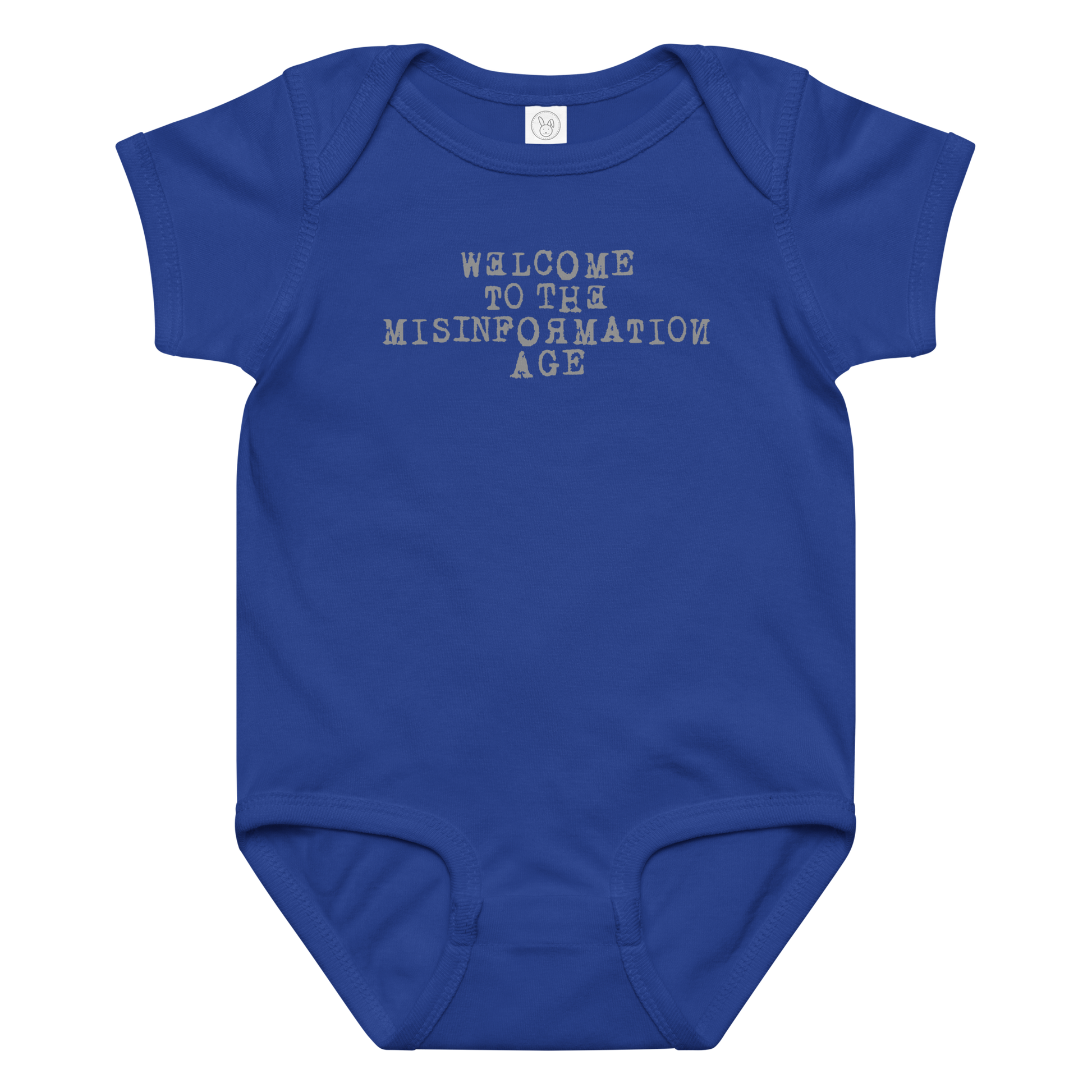 "Welcome to the misinformation age" printed on a royal baby jersey bodysuit laying on a flat surface amongst other clothes