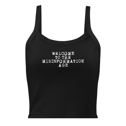 "Welcome to the misinformation age" printed on a solid black blend women's micro-rib tanktop laying on a flat surface