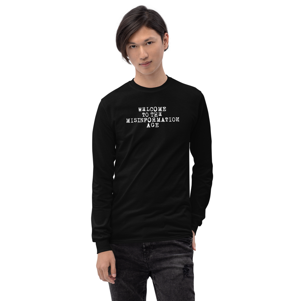 "Welcome to the misinformation age" printed on a black men's long sleeve shirt worn by a male