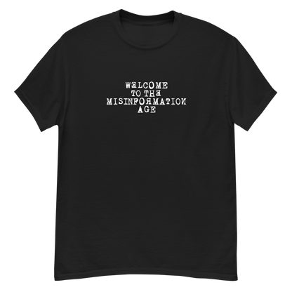 "Welcome to the misinformation age" printed on a black unisex classic tee laying on a flat surface