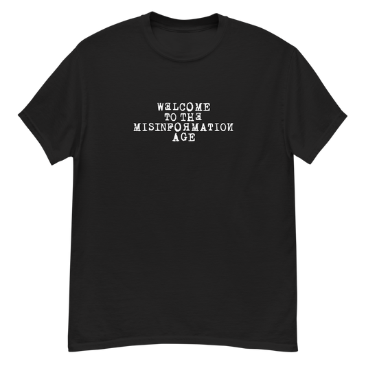 "Welcome to the misinformation age" printed on a black unisex classic tee laying on a flat surface