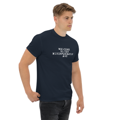 "Welcome to the misinformation age" printed on a navy unisex classic tee worn by a male