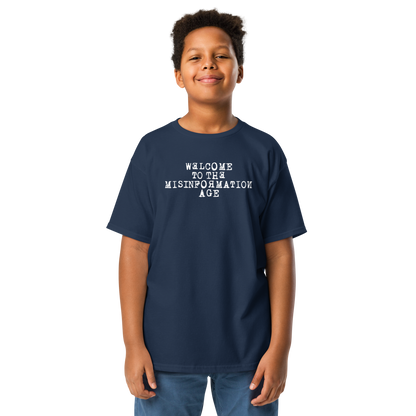 "Welcome to the misinformation age" printed on a navy youth classic tee worn by a male