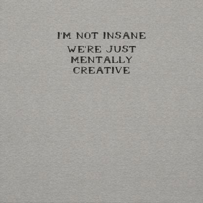 "I’m not insane   We’re just mentally creative" printed on a carbon grey background