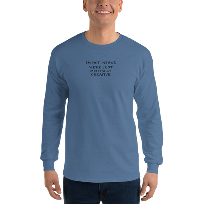"I’m not insane   We’re just mentally creative" printed on a indigo blue men's long sleeve shirt worn by a male