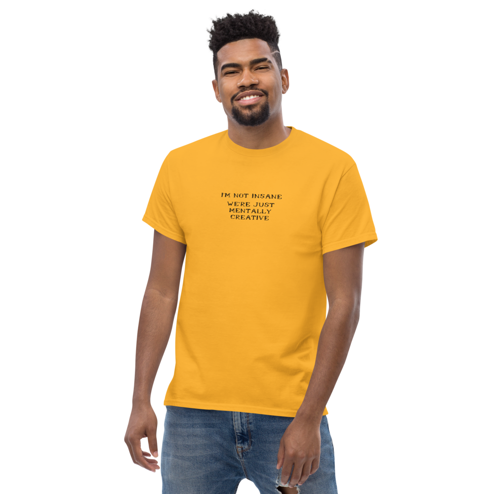 "I’m not insane   We’re just mentally creative" printed on a gold unisex classic tee worn by a male
