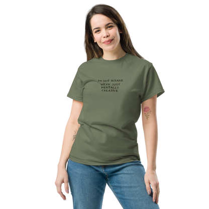 "I’m not insane   We’re just mentally creative" printed on a military green unisex classic tee worn by a female
